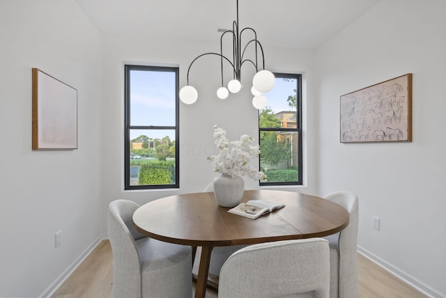 583 E Walnut St, Columbus, OH 43215 - dining space with light wood-style flooring and a chandelier