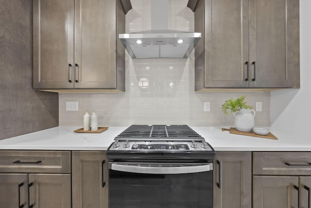 583 E Walnut St, Columbus, OH 43215 - kitchen featuring extractor fan, stainless steel range with gas cooktop, light countertops, and backsplash