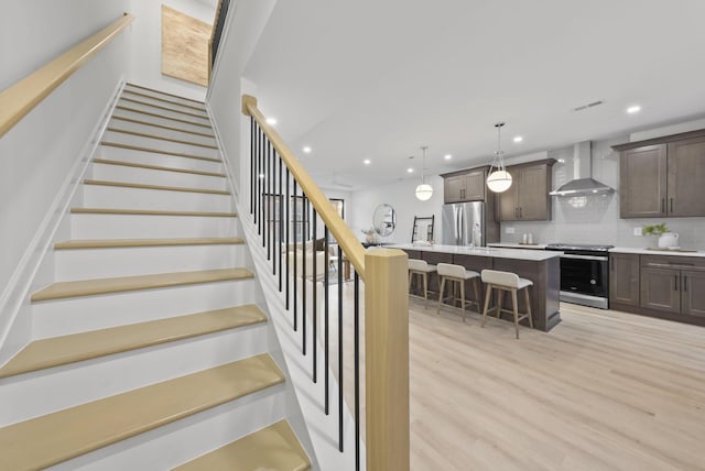 583 E Walnut St, Columbus, OH 43215 - staircase with wood finished floors and recessed lighting