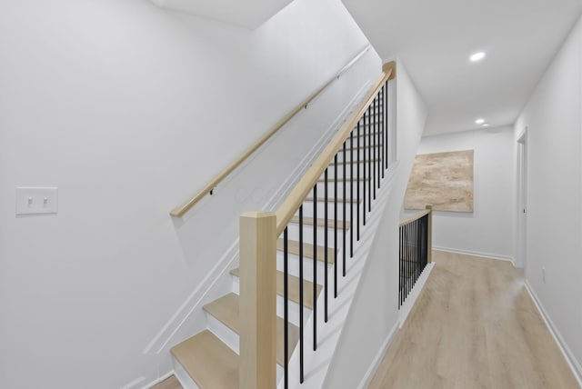 583 E Walnut St, Columbus, OH 43215 - stairway featuring wood finished floors and recessed lighting