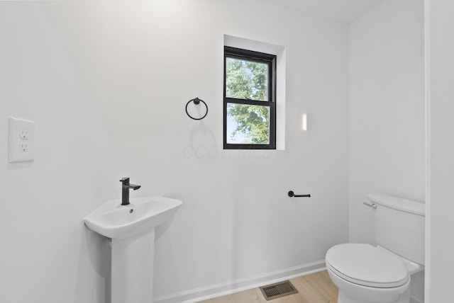583 E Walnut St, Columbus, OH 43215 - half bathroom with toilet and wood finished floors