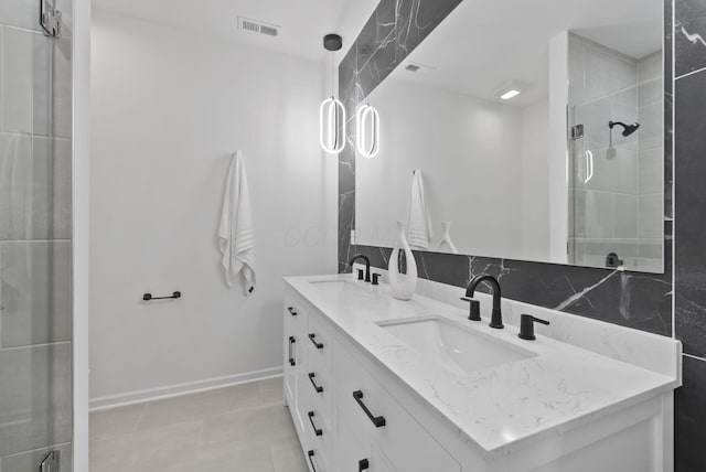 583 E Walnut St, Columbus, OH 43215 - full bathroom featuring double vanity, a tile shower, and tile patterned floors