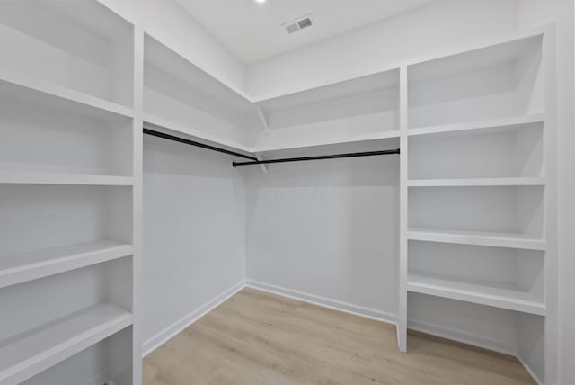 583 E Walnut St, Columbus, OH 43215 - walk in closet featuring wood finished floors