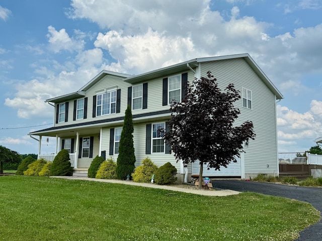 3701 Swisher Rd, Crestline, OH 44827 - view of front of home with driveway, a front lawn, covered porch, and a garage