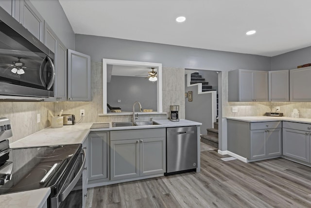 716 N Mount Pleasant Ave, Lancaster, OH 43130 - kitchen with appliances with stainless steel finishes, gray cabinets, a ceiling fan, light wood-type flooring, and recessed lighting