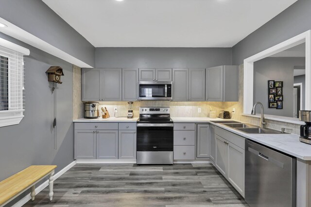 716 N Mount Pleasant Ave, Lancaster, OH 43130 - kitchen featuring stainless steel appliances, gray cabinetry, light countertops, backsplash, and wood finished floors