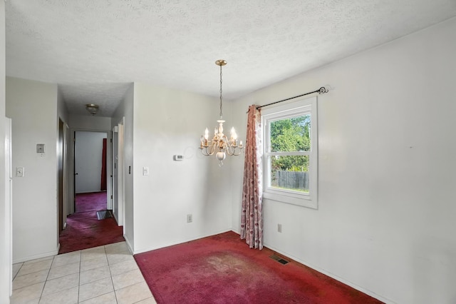 617 Athens St, Columbus, OH 43204 - unfurnished dining area featuring light colored carpet, a chandelier, light tile patterned floors, and a textured ceiling