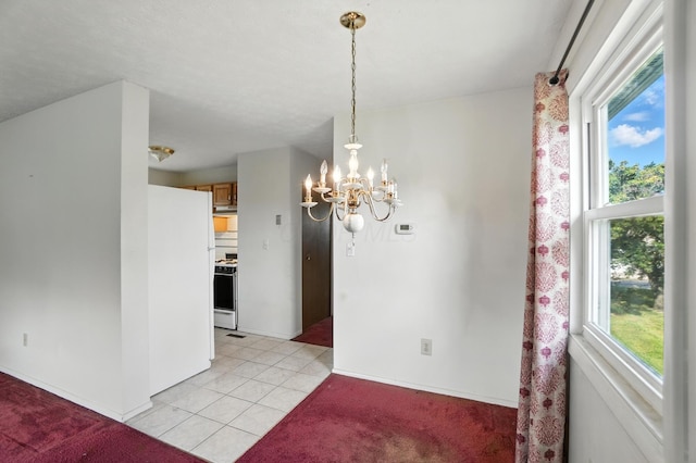 617 Athens St, Columbus, OH 43204 - unfurnished dining area featuring plenty of natural light, a chandelier, light tile patterned floors, and light colored carpet