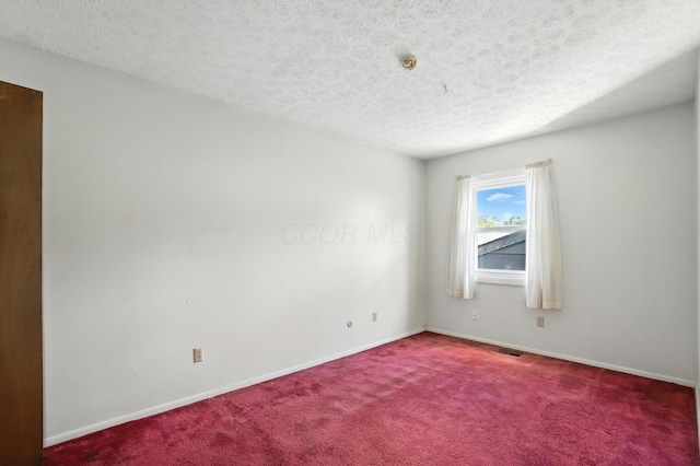 617 Athens St, Columbus, OH 43204 - carpeted empty room with baseboards and a textured ceiling