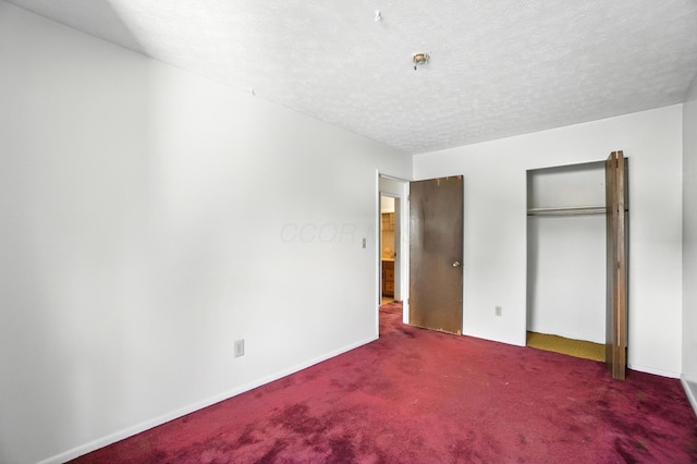 617 Athens St, Columbus, OH 43204 - unfurnished bedroom with carpet, a closet, and a textured ceiling