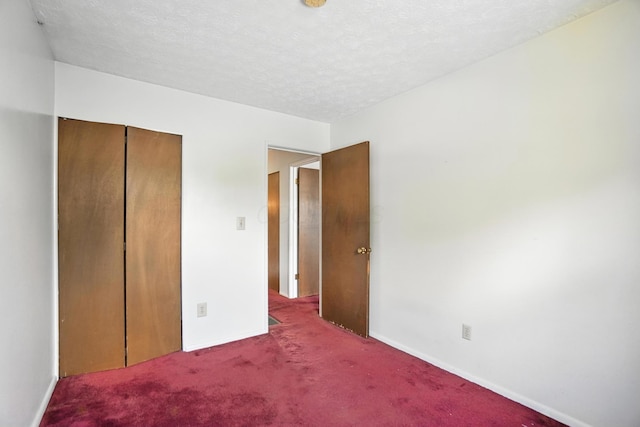 617 Athens St, Columbus, OH 43204 - unfurnished bedroom with carpet, a closet, and a textured ceiling