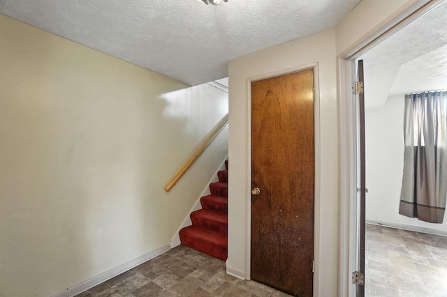 617 Athens St, Columbus, OH 43204 - stairway with stone finish flooring and a textured ceiling