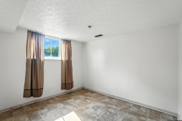 617 Athens St, Columbus, OH 43204 - unfurnished room with stone finish floors, a textured ceiling, and fire sprinkler in ceiling