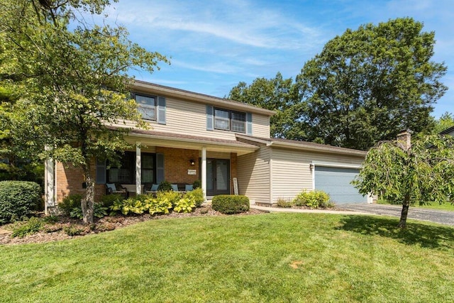 7107 Stone Ct, Columbus, OH 43235 - traditional home with driveway, a garage, a front yard, and a porch