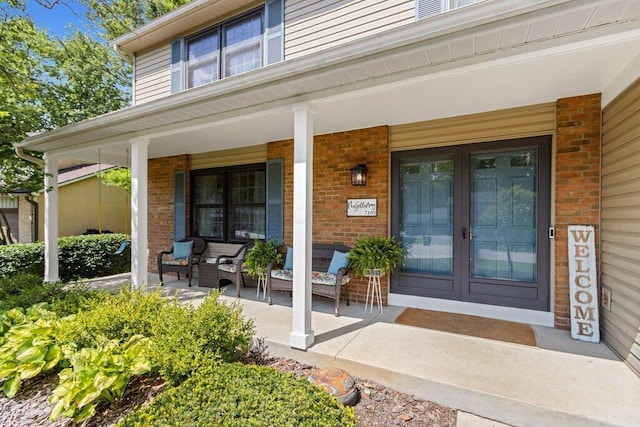 7107 Stone Ct, Columbus, OH 43235 - doorway to property featuring covered porch, brick siding, and french doors