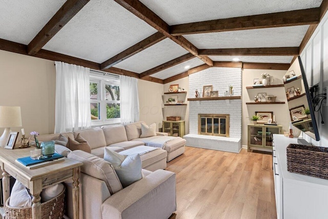 7107 Stone Ct, Columbus, OH 43235 - living room featuring light wood-style floors, a fireplace, and a textured ceiling
