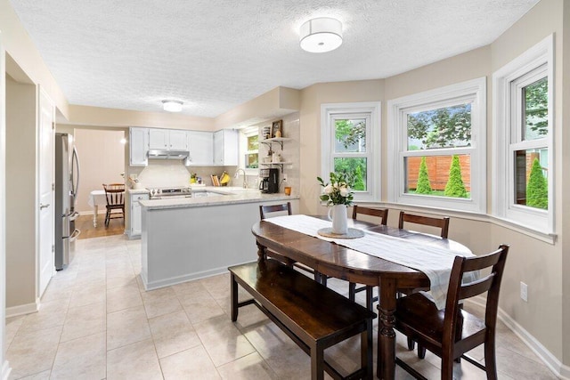 7107 Stone Ct, Columbus, OH 43235 - dining space featuring a textured ceiling and light tile patterned floors