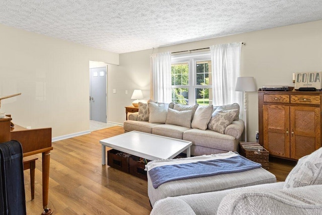 7107 Stone Ct, Columbus, OH 43235 - living room with light wood finished floors and a textured ceiling