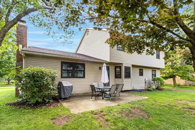 7107 Stone Ct, Columbus, OH 43235 - back of property featuring a chimney, a yard, and a patio