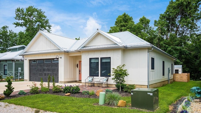 58 Lippert Ln, Buckeye Lake, OH 43008 - modern farmhouse with an attached garage, concrete driveway, a metal roof, and board and batten siding