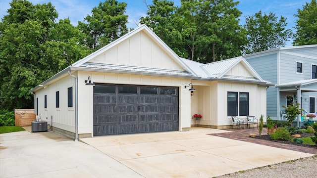 58 Lippert Ln, Buckeye Lake, OH 43008 - modern inspired farmhouse featuring board and batten siding, concrete driveway, an attached garage, and a metal roof