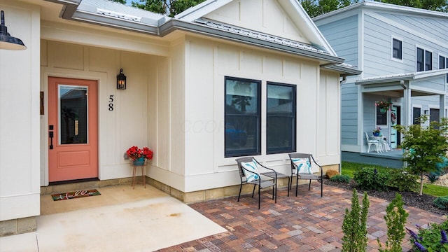 58 Lippert Ln, Buckeye Lake, OH 43008 - view of exterior entry with a patio and board and batten siding