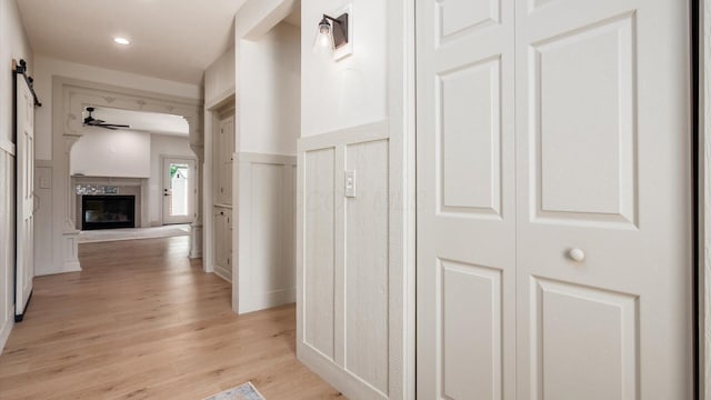 58 Lippert Ln, Buckeye Lake, OH 43008 - hallway with a decorative wall, light wood finished floors, wainscoting, and recessed lighting