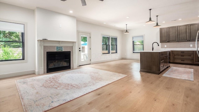 58 Lippert Ln, Buckeye Lake, OH 43008 - kitchen featuring an island with sink, dark brown cabinets, plenty of natural light, a ceiling fan, and recessed lighting