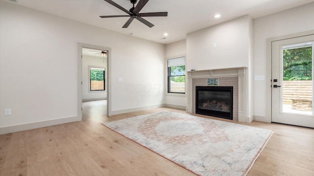 58 Lippert Ln, Buckeye Lake, OH 43008 - unfurnished living room featuring a ceiling fan, light wood-style floors, a glass covered fireplace, and recessed lighting