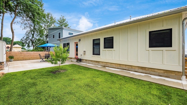 58 Lippert Ln, Buckeye Lake, OH 43008 - rear view of property featuring board and batten siding and a patio