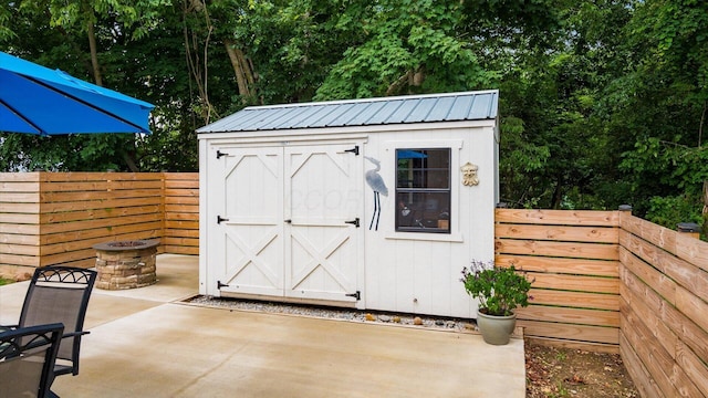 58 Lippert Ln, Buckeye Lake, OH 43008 - view of shed featuring a fire pit and a fenced backyard