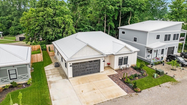 58 Lippert Ln, Buckeye Lake, OH 43008 - view of front of house with driveway, an attached garage, a metal roof, a standing seam roof, and a front yard