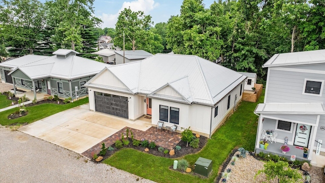 58 Lippert Ln, Buckeye Lake, OH 43008 - view of front of property with driveway, a garage, board and batten siding, and a front lawn