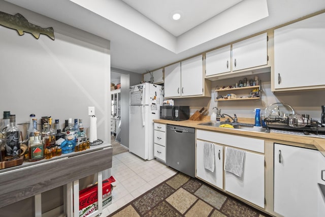 1290 Paddington Ct, Columbus, OH 43230 - kitchen featuring dishwasher, freestanding refrigerator, black microwave, white cabinets, and light tile patterned flooring