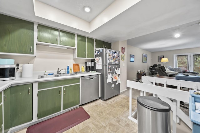 1290 Paddington Ct, Columbus, OH 43230 - kitchen featuring green cabinets, appliances with stainless steel finishes, light countertops, open floor plan, and stone finish floors