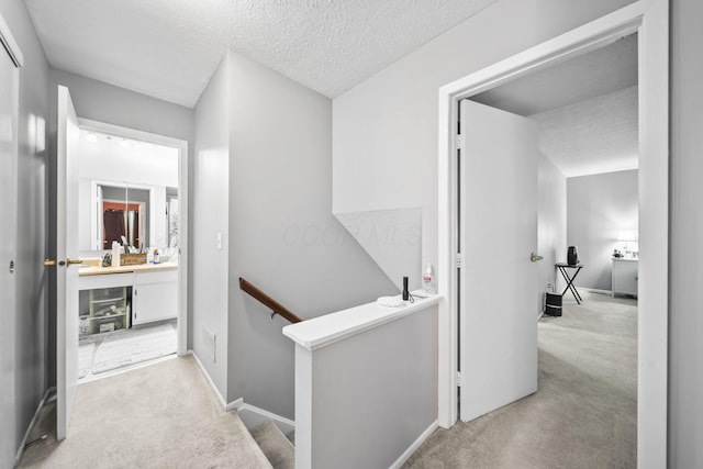 1290 Paddington Ct, Columbus, OH 43230 - corridor featuring light carpet, an upstairs landing, and a textured ceiling