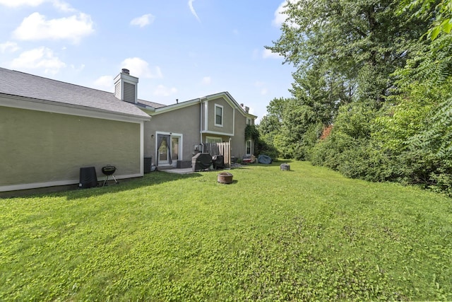 1290 Paddington Ct, Columbus, OH 43230 - view of green lawn with an outdoor fire pit