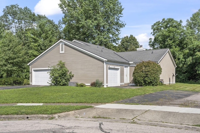 1290 Paddington Ct, Columbus, OH 43230 - view of side of home with a yard, a chimney, an attached garage, and a shingled roof