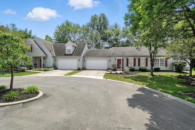 6281 Mcnaughten Place Ln Unit 24, Columbus, OH 43213 - view of front facade with an attached garage, driveway, and a front lawn