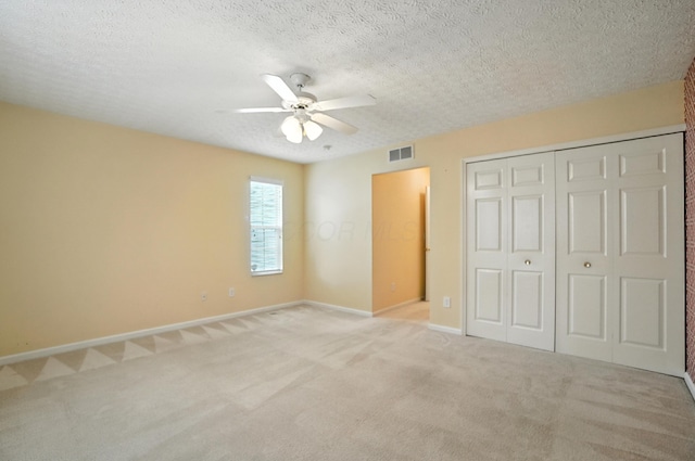 6281 Mcnaughten Place Ln Unit 24, Columbus, OH 43213 - unfurnished bedroom with carpet floors, a closet, ceiling fan, and a textured ceiling