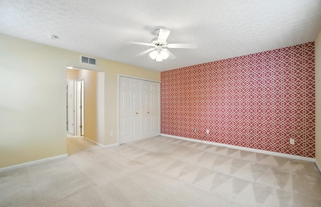 6281 Mcnaughten Place Ln Unit 24, Columbus, OH 43213 - unfurnished bedroom with light colored carpet, a closet, a textured ceiling, and a ceiling fan