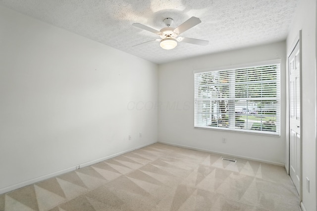 6281 Mcnaughten Place Ln Unit 24, Columbus, OH 43213 - empty room featuring a textured ceiling, light colored carpet, and ceiling fan