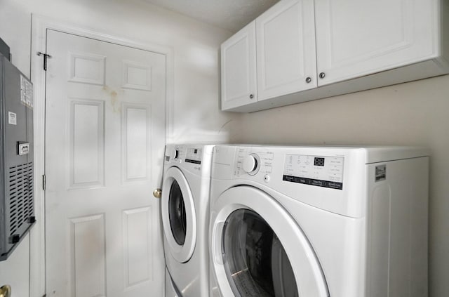 6281 Mcnaughten Place Ln Unit 24, Columbus, OH 43213 - laundry area with washer and clothes dryer and cabinet space
