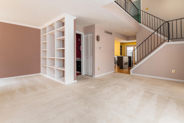 5613 Chowning Way, Columbus, OH 43213 - unfurnished living room with carpet flooring, stairway, and built in shelves