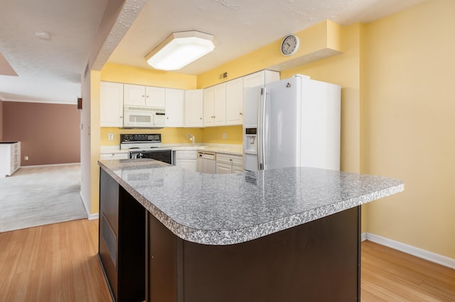 5613 Chowning Way, Columbus, OH 43213 - kitchen featuring white appliances, light wood-style flooring, white cabinets, and a spacious island