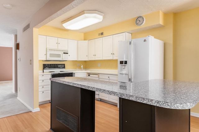 5613 Chowning Way, Columbus, OH 43213 - kitchen featuring white appliances, a kitchen island, light wood-style floors, white cabinets, and light countertops