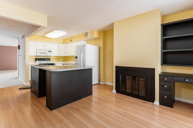 5613 Chowning Way, Columbus, OH 43213 - kitchen with white appliances, light wood-style floors, white cabinets, a kitchen island, and light countertops