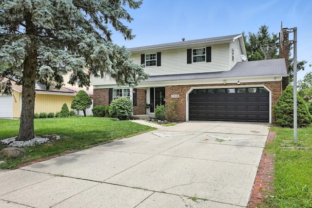 5328 Torchwood Loop E, Columbus, OH 43229 - traditional-style house with brick siding, a front yard, and driveway