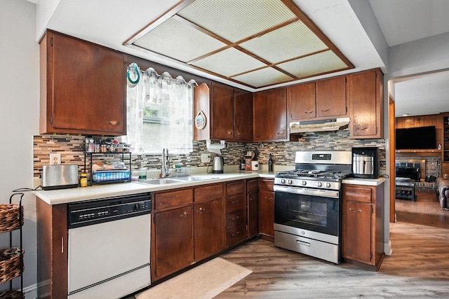 5328 Torchwood Loop E, Columbus, OH 43229 - kitchen featuring white dishwasher, gas stove, light countertops, under cabinet range hood, and wood finished floors
