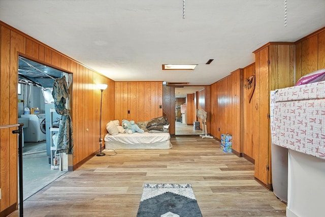 5328 Torchwood Loop E, Columbus, OH 43229 - bedroom featuring wooden walls, light wood-style flooring, and washer / dryer